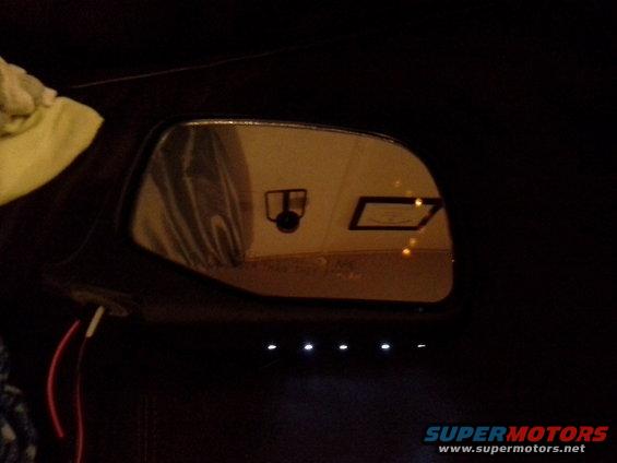 Interior mirror with camera and indicator lights