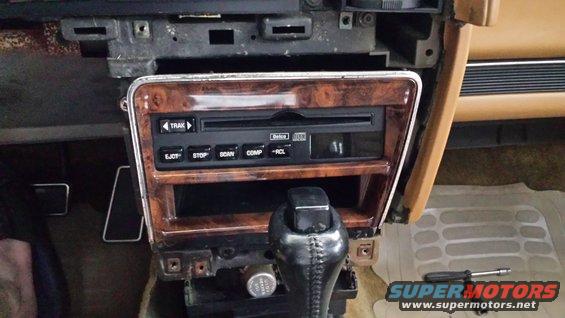 Car interior showing woodgrain trim, CD player, and gear shifter