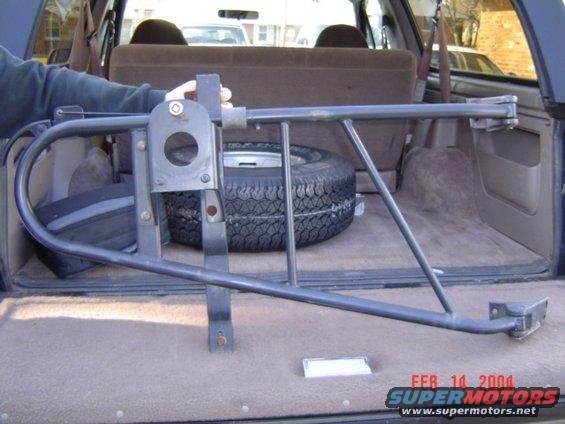 1994 Ford Bronco interior with spare tire rack and spare tire. Dark blue exterior