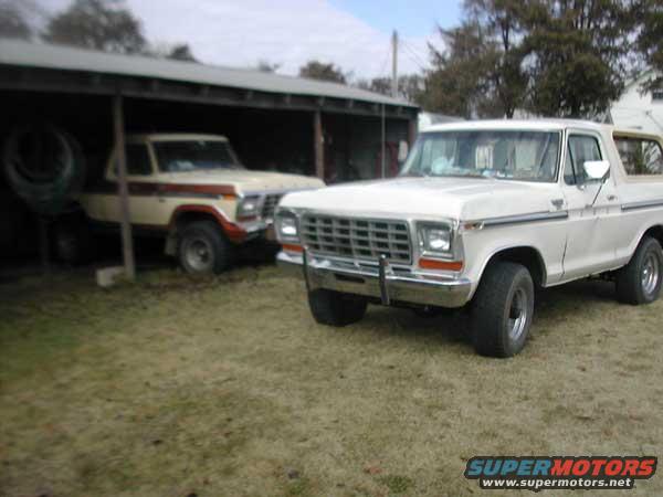 White 1979 Ford Bronco parked outside, with another older Bronco in the background