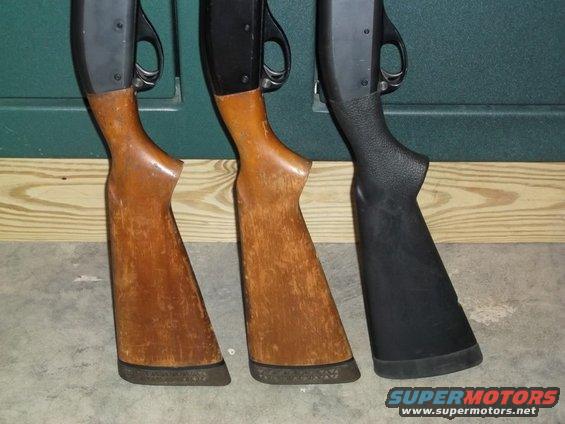 Three shotgun stocks, two wood and one black, lined up against a green wall