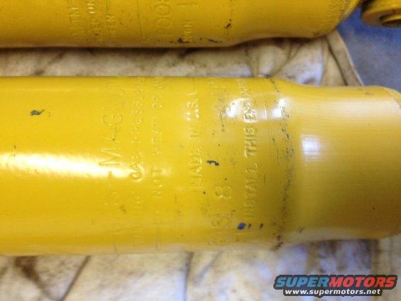 Yellow shock absorber with "MAGNUM" and "MADE IN U.S.A." text