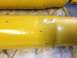 1973 Ford Bronco - Close-up of yellow shock absorbers with visible text indicating "MAGNUM" and "MADE IN U.S.A."