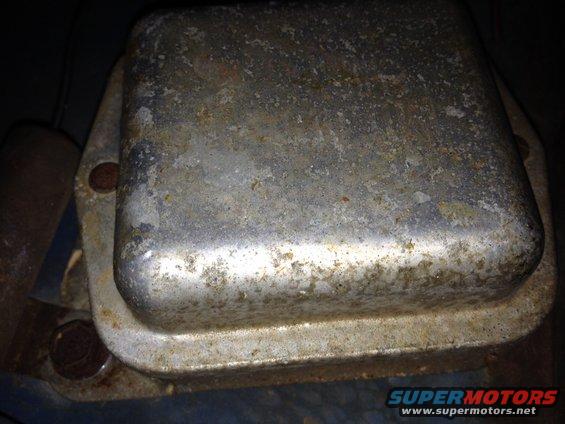 Close-up of a rusty voltage regulator