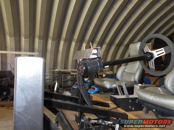 custom racing simulator with bucket seats and steering wheel in a workshop