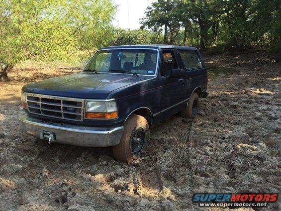1993 Ford Bronco stuck in mud, 3/4 front view