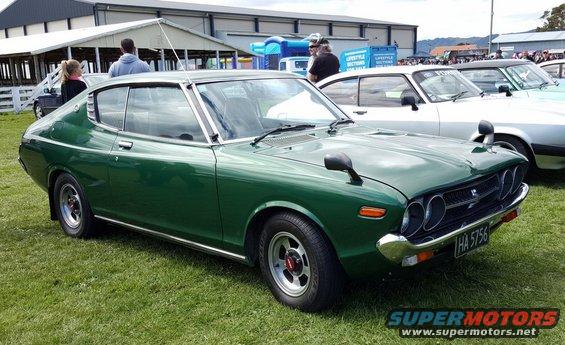 Green coupe with chrome trim, fender mirrors, and a license plate reading HA 5756
