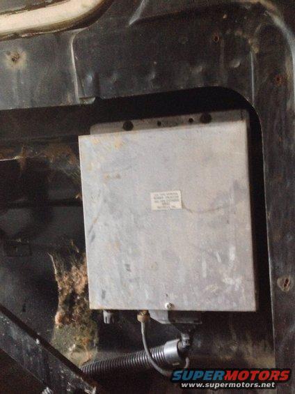 Engine control unit mounted in vehicle, with wiring harness and some debris