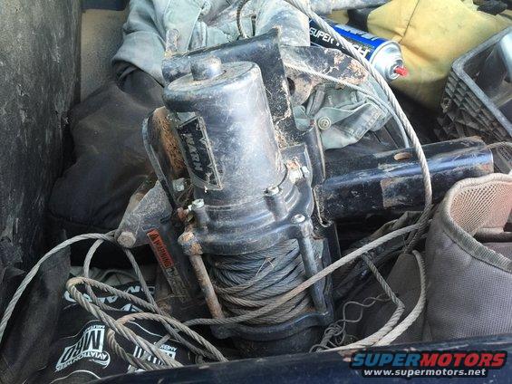 Winch with WARN label and coiled cable