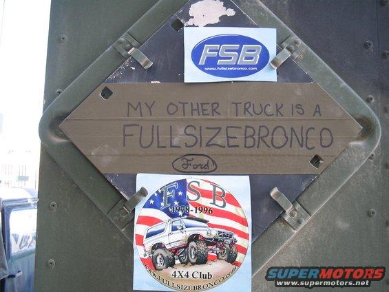 Stickers and a sign that says 'MY OTHER TRUCK IS A FULLSIZEBRONCO' on a green metal surface