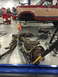1984 Ford Bronco - The front axle assembly of a Ford Bronco is being worked on in a garage, garage setting.