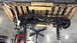 1984 Ford Bronco - Front axle and suspension components are shown disassembled and mounted on a pallet.