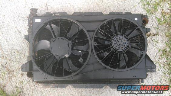 3.jpg Dual electric fans from a 04-07 Ford Freestar. its Dorman 620-144 and cost about ~120$ depending on supplier

this is on a 80-96 bronco/f-series radiator for size comparison. it coers pretty much all the finned area of the radiator and is alittle wide but can be made to work.

this is it on the inside of the radiator. it will need some modifinig here and there. cutting the tabs off, notche the shroud for the hoses and tranny cooler lines. 