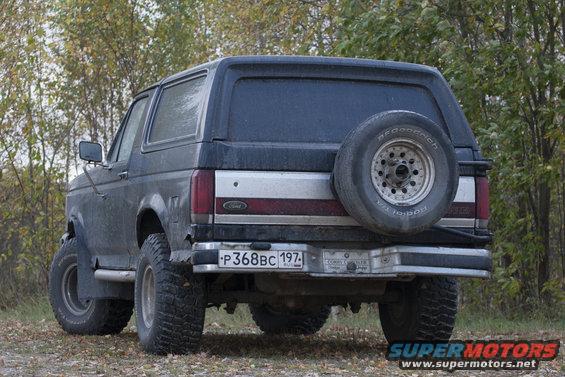 Rear view of a dark gray 1987 Ford Bronco with a spare tire mounted externally
