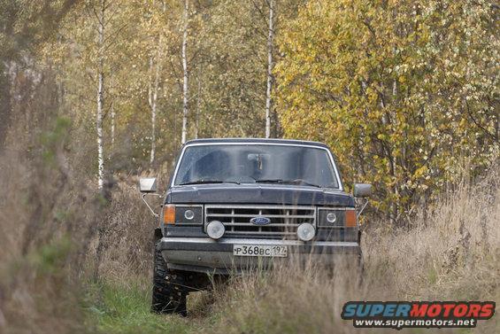 1987 Ford Bronco front view on a dirt road