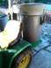 1982 Kubota RTV900 - A Trac Vac leaf collection system is attached to a green tractor, which has tire chains on its rear wheel.