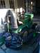 1982 Kubota RTV900 - John Deere lawn tractor with a bagger attachment and hose connected.