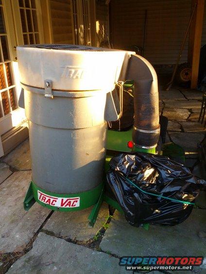 Trac Vac leaf vacuum with a black trash bag attached