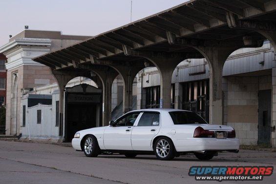 white sedan parked under a covered walkway