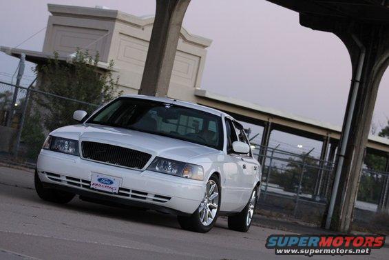White 2000 Mercury Grand Marquis sedan with a Ford Racing license plate, seen from a 3/4 front angle