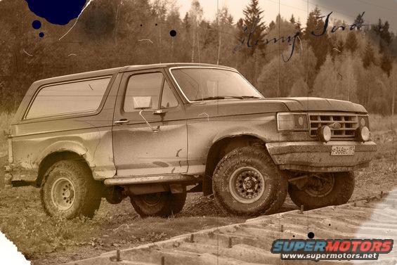 1987 Ford Bronco parked on dirt road, side view
