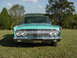 1964 Mercury Comet - This turquoise sedan features a prominent chrome grille and dual headlights, with a license plate reading EUM 058.