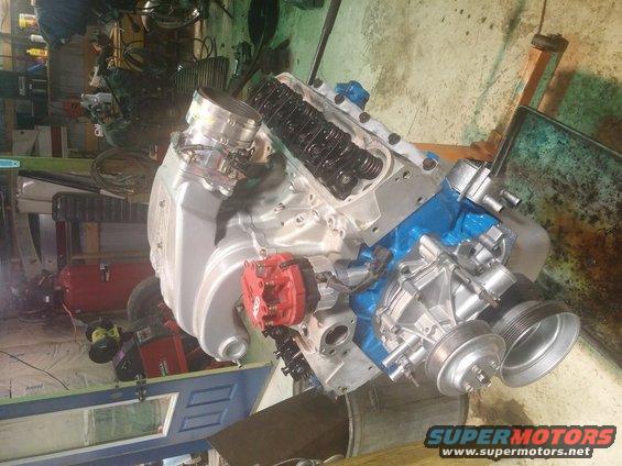 Engine block with blue paint, silver intake, and red distributor cap