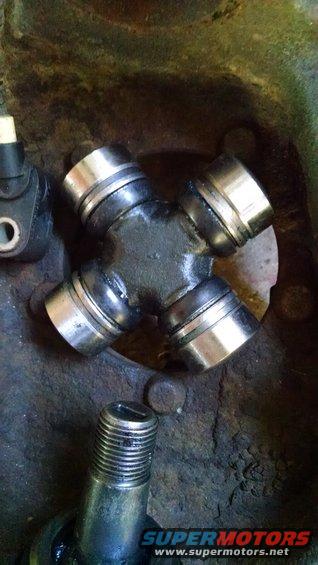 Universal joint with threaded bolt below. Supermotors.net logo visible