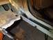 1991 Ford Bronco - Repair work on a vehicle's floor pan and rocker panel shows significant rust damage.
