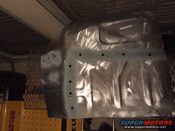 Bare metal floor pan with stamped ribs and mounting holes