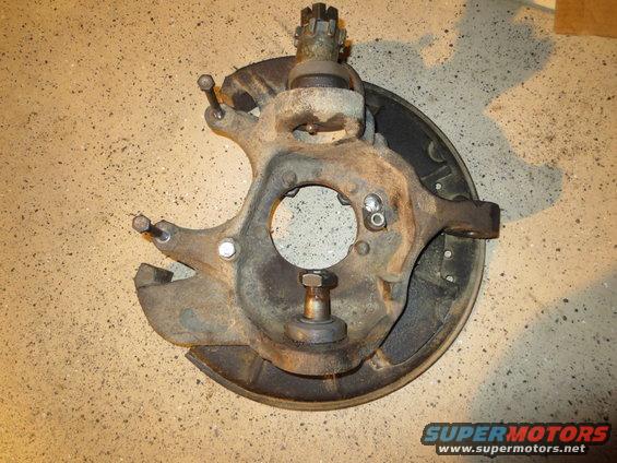 Front wheel knuckle assembly with ball joint and brake drum backing plate