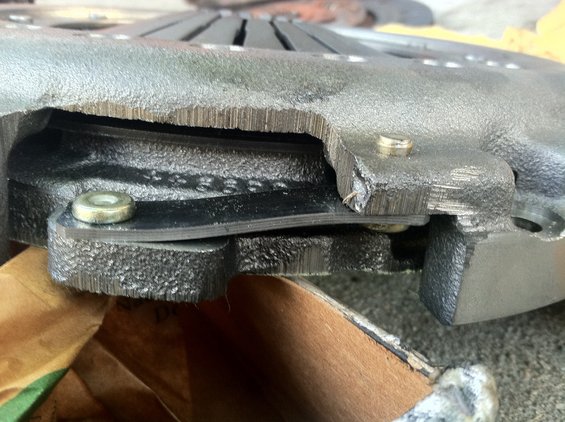 Close-up of a clutch pressure plate with visible wear and damage