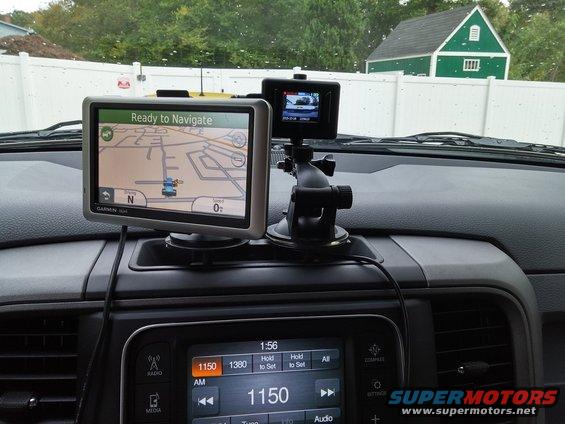 Dashboard with Garmin GPS and dashcam mounted. Radio display shows 1150 AM