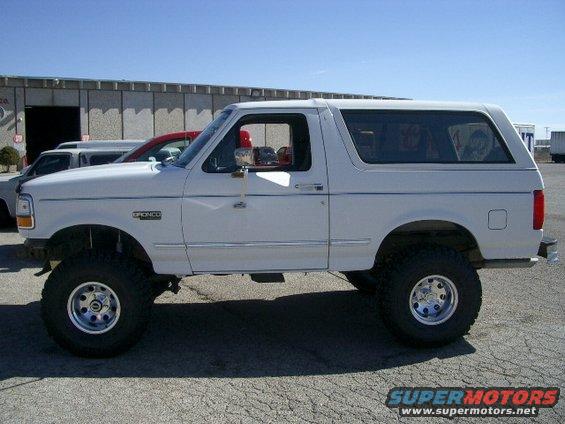White 1994 Ford Bronco parked outside a building