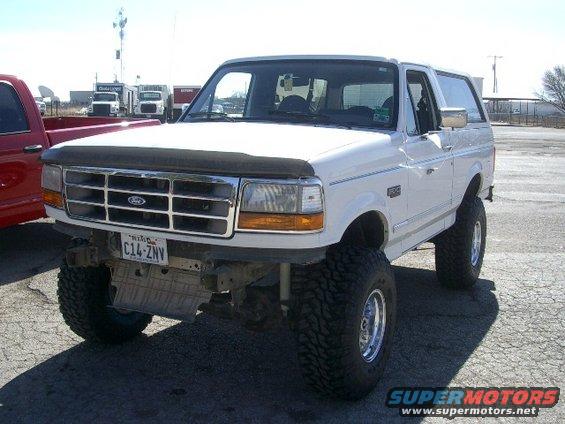 White 1994 Ford Bronco with lifted suspension and large tires