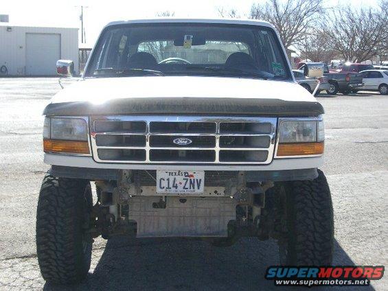 White Ford Bronco with a chrome grille and Texas license plate, lifted with large tires