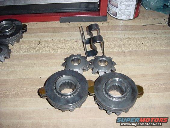 Differential gears and a metal clip on a wooden surface