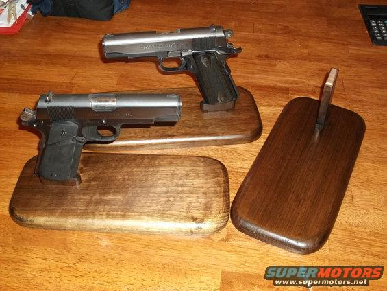 Two handguns on wooden stands