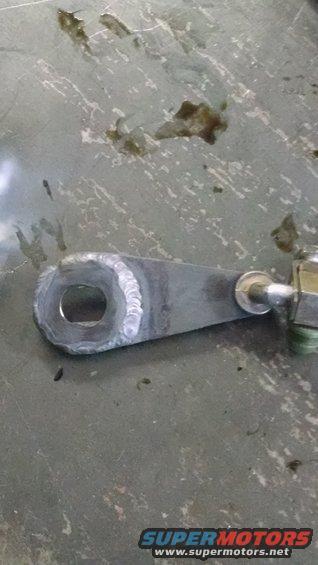 Welded metal linkage with a circular hole and a bolt assembly