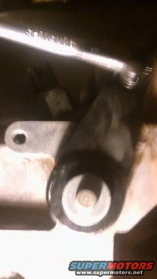 close-up of a metal suspension part with a bolt and washer