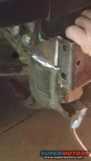 Metal lift bracket with bolts and wires, close-up view