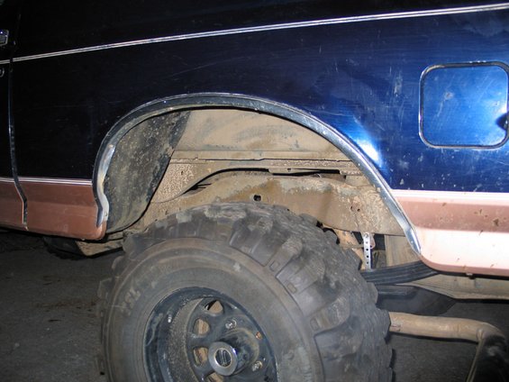Side view of 1995 Ford Bronco rear wheel well with large tire and suspension components