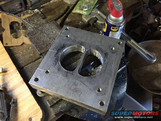 rough-holes.jpg Got the straight through section of the ports roughed out. Now to grind the angles in to match both ports. I used a aluminum-specific carbide burr for this.