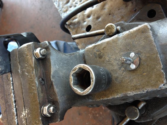 Socket wrench attached to a metal vise with bolts