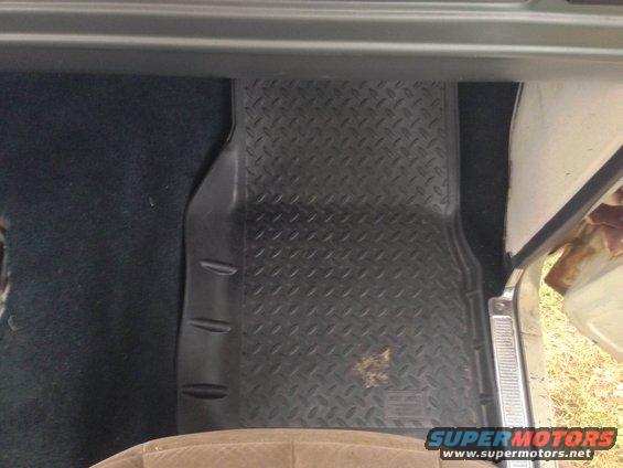 Close-up of a black diamond plate floor mat in a vehicle's interior