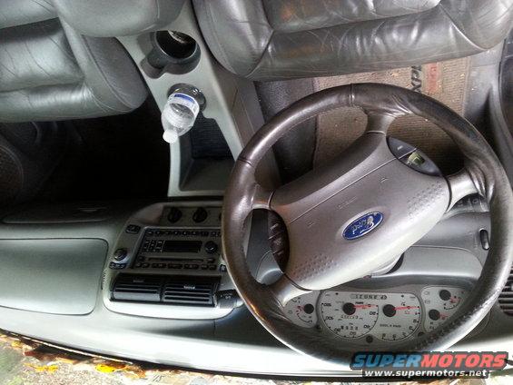 Interior of a 2001 Ford Explorer showing the steering wheel and dashboard