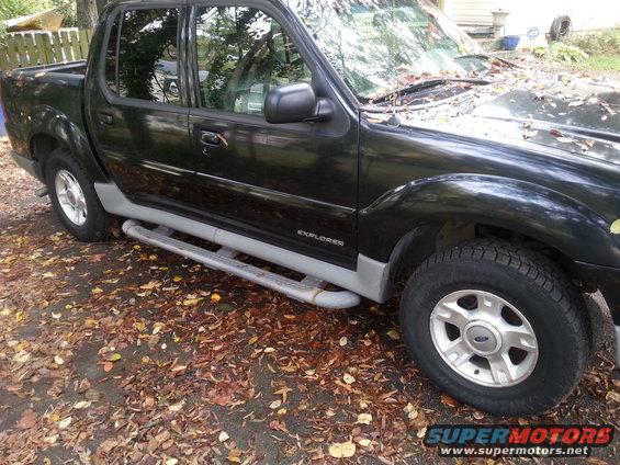 2001 Ford Explorer Sport Trac pickup truck parked on a leaf-covered ground