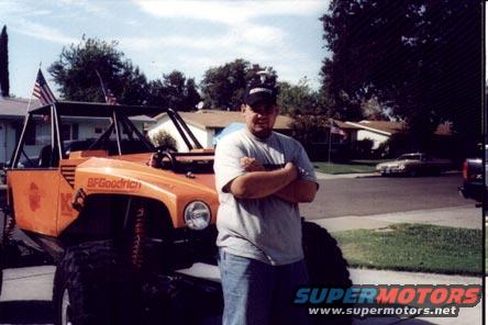 Custom orange off-road vehicle with BFGoodrich tires and a man standing next to it