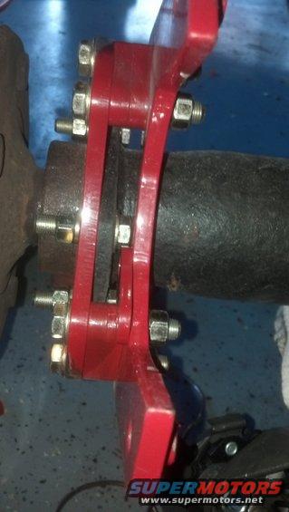 The caliper now just barely clears the mounting bolt.  The mounting boss is now visible on the inboard side.