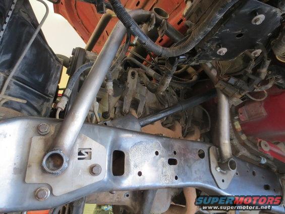 Vehicle frame with suspension components and wiring. Some rust visible